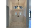 Bright entryway with double doors and a crystal chandelier at 234 Antofagasta St, Punta Gorda, FL 33983