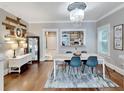 Bright dining room with hardwood floors, a farmhouse table, and stylish blue chairs at 909 E Cayuga St # A, Tampa, FL 33603