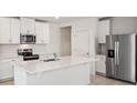 Modern kitchen with stainless steel appliances and white cabinets at 113 Whiteland Bnd, Nokomis, FL 34275