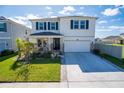 Two-story house with a white exterior and a stone facade at 8493 Hardy Bay Loop, Wesley Chapel, FL 33545