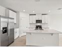 Modern kitchen with stainless steel appliances and white cabinetry at 164 Lazy Shore Dr, Nokomis, FL 34275