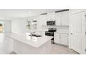 Bright kitchen, featuring an island and stainless steel appliances at 180 Lazy Shore Dr, Nokomis, FL 34275