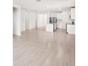 Open living space with modern tile flooring and kitchen access at 188 Lazy Shore Dr, Nokomis, FL 34275