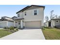 Charming two-story home featuring a two car garage and neutral siding at 3910 Radiant Mountain Dr, Plant City, FL 33565