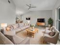 Bright living room with comfortable seating, a large TV, and stylish decor at 18978 Mcgrath Cir, Port Charlotte, FL 33948