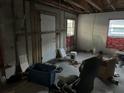 Unfinished interior room with exposed framing and flooring at 6114 S 3Rd St, Tampa, FL 33611