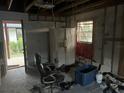 Unfinished room with exposed framing and a refrigerator at 6114 S 3Rd St, Tampa, FL 33611