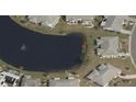 Aerial view of a home backing to a beautiful pond with fountain feature, in a residential community at 906 Bluewater Dr, Sun City Center, FL 33573
