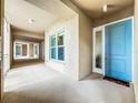 Exterior hallway view with light blue door and neutral colored walls at 10530 Boardwalk Loop # 304, Lakewood Ranch, FL 34202