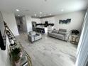 Open living room with gray sofas and modern decor at 10922 Brightleaf Ct, Riverview, FL 33569