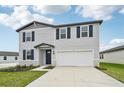 Two-story house with gray siding, navy blue shutters, and a white garage door at 161 Lazy Shore Dr, Nokomis, FL 34275