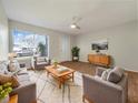 Bright living room with mid-century modern furniture at 8381 Chelsea Ct, North Port, FL 34287