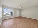 Bright living room with wood-look floors and view of front yard at 8381 Chelsea Ct, North Port, FL 34287