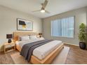 Spacious bedroom with wood-look floors, ceiling fan and large window at 8381 Chelsea Ct, North Port, FL 34287