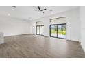 Spacious living room featuring modern tile floors, recessed lighting, and backyard views at 16440 Cape Horn Blvd, Punta Gorda, FL 33955