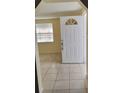 Home entryway with tile flooring and white door at 3023 W Green St, Tampa, FL 33607
