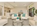 Open concept living area with white sofa and glass coffee table at 17013 Alpenhorn Ct, Punta Gorda, FL 33955