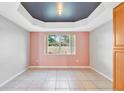Bright dining room with a tray ceiling and pink walls at 2443 Waterfall Dr, Spring Hill, FL 34608