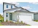 Contemporary two-story home with a two-car garage, appealing exterior finishes, and fresh landscaping at 14044 Crutchfield Ct, Parrish, FL 34219