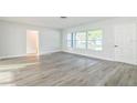 Living room with wood-look floors and large window at 1845 Skyland Dr, Clearwater, FL 33759