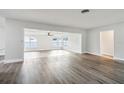 Open living room with wood-look floors and lots of light at 1845 Skyland Dr, Clearwater, FL 33759