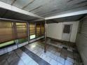 Enclosed patio with tiled floor and exterior door at 9431 Pontiac St, New Port Richey, FL 34654