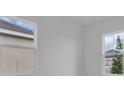 Bright bedroom with two windows showcasing the exterior of the property at 2515 Wise River Lane, Zephyrhills, FL 33539