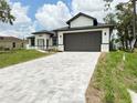 Inviting home exterior with a paved driveway, offering a glimpse of the front yard and modern design at 4683 Boston Ter, North Port, FL 34288
