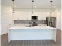 Modern kitchen featuring a center island, stainless steel appliances, and stylish pendant lighting at 1081 Mccrory St, North Port, FL 34286