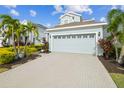Two-story house with light blue exterior, gray roof and a paved driveway at 307 Shore Crab Way, Apollo Beach, FL 33572