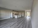 Open living room with modern flooring and access to the kitchen at 22139 Lockport Ave, Port Charlotte, FL 33952