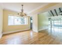 View of the dining room with hardwood floors, chandelier, and large window at 13619 Twin Lakes Ln # 15, Tampa, FL 33618
