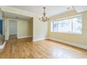 View of the dining room featuring hardwood floors, large window, and chandelier at 13619 Twin Lakes Ln # 15, Tampa, FL 33618