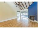 Open living room with vaulted ceiling, ceiling fan, hardwood floors and fireplace at 13619 Twin Lakes Ln # 15, Tampa, FL 33618
