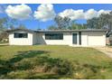 Ranch style home with white exterior and a two car garage at 2239 Worrington St, Sarasota, FL 34231