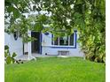 House exterior view, featuring a lush green lawn and mature trees at 5400 Circle Dr, Weeki Wachee, FL 34607