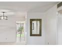 Bright living room with mirror and view to patio at 5095 Bay Ne St # 109, St Petersburg, FL 33703