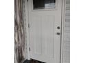 White front door with classic panel design and a glass window, offering a bright and welcoming entrance at 6728 Sea Ranch Dr, Hudson, FL 34667