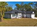 Single-story home showcasing landscaping and a large backyard at 3890 W Price Blvd, North Port, FL 34286