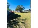 Large backyard with grassy area and small deck at 6336 Florida Cir, Apollo Beach, FL 33572