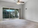 Spacious living room featuring a sliding glass door to a balcony at 10241 Spanish Breeze Ct, Riverview, FL 33578