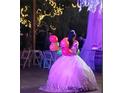 Young Personal in a quinceañera dress holding balloons at 15625 State Road 62 St, Parrish, FL 34219