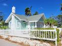 Side view of a charming light green house at 708 22Nd W St, Bradenton, FL 34205