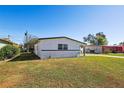 Side view of the house showcasing its freshly painted exterior and landscaping at 6007 Ambassador Dr, Tampa, FL 33615