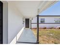 Covered entryway with a dark front door and white brick exterior at 6007 Ambassador Dr, Tampa, FL 33615