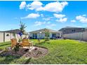 Landscaped backyard with a patio and seating area at 7729 Rosewood Garden Loop, Tampa, FL 33637