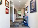 Bright hallway features stylish decor and leads to a spacious living area at 7729 Rosewood Garden Loop, Tampa, FL 33637