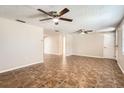 Bright living room featuring tile floors and ceiling fans at 5023 Thames Dr, New Port Richey, FL 34652