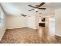 Spacious living room with tile flooring and ceiling fans at 5023 Thames Dr, New Port Richey, FL 34652