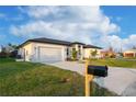 Front view of a single-story house with a driveway and mailbox at 10625 Ayear Rd, Port Charlotte, FL 33981